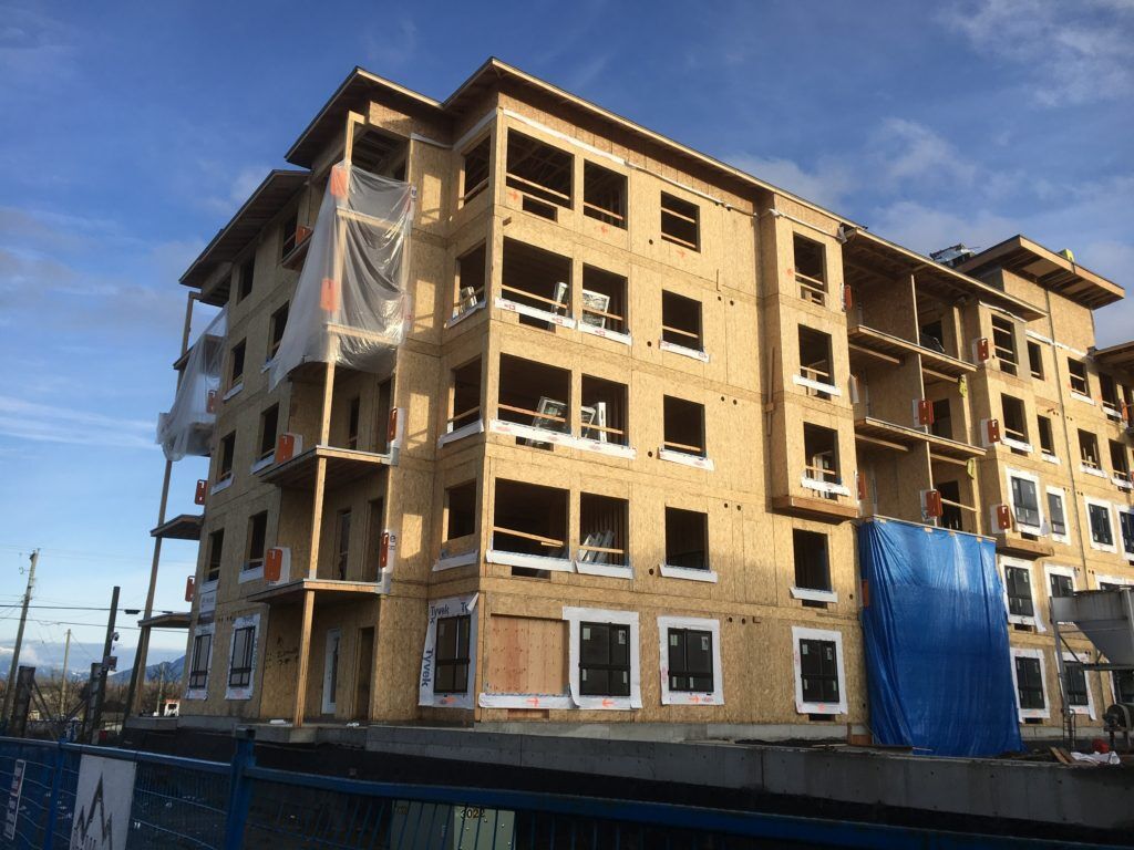 5-story apartment complex with balconies under construction