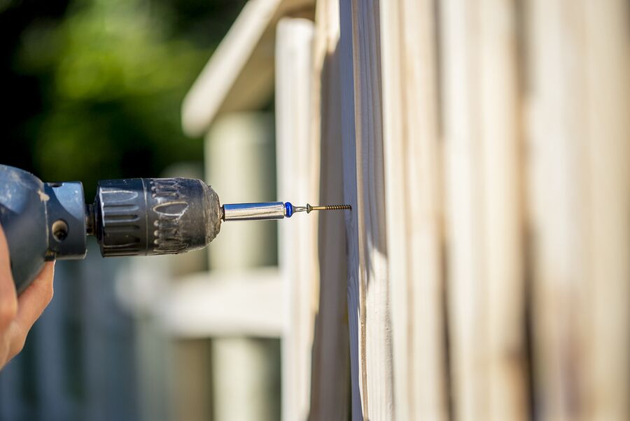 Person drilling in a screw with electric drill