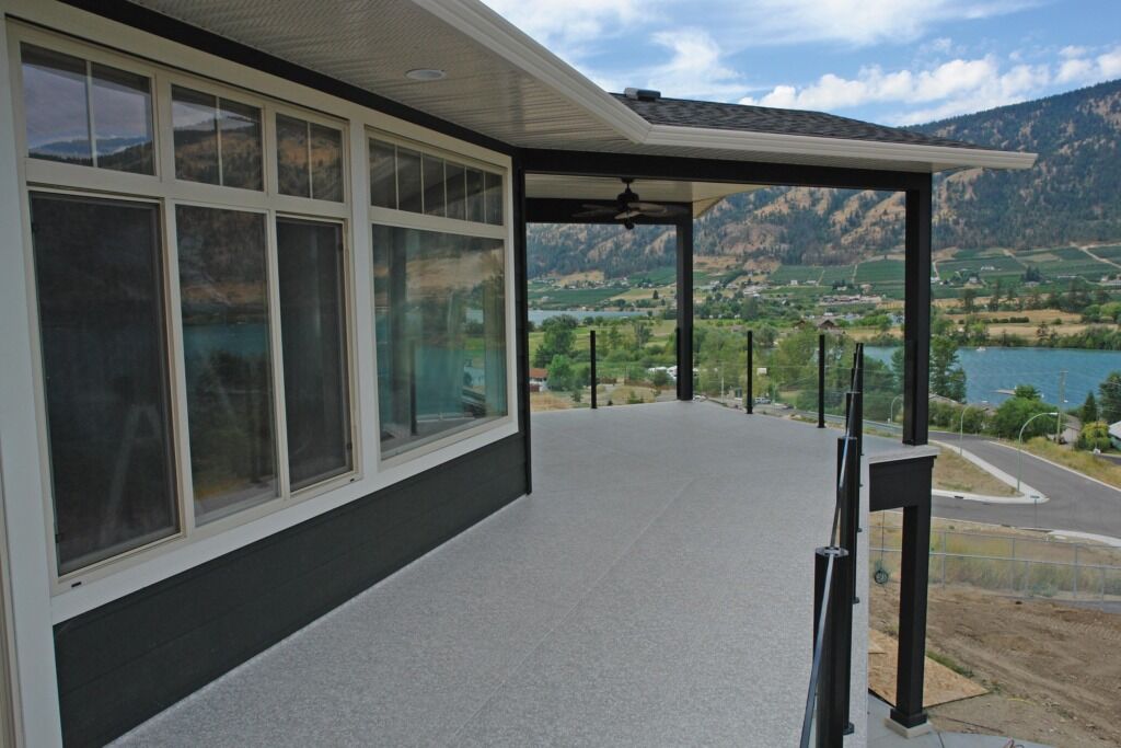 Econodek waterproof decking system installed on an Okanagan home with view of a lake.