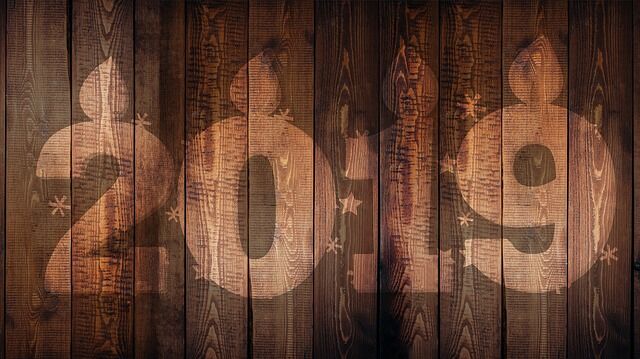 2019 New Year etched in wood plank background